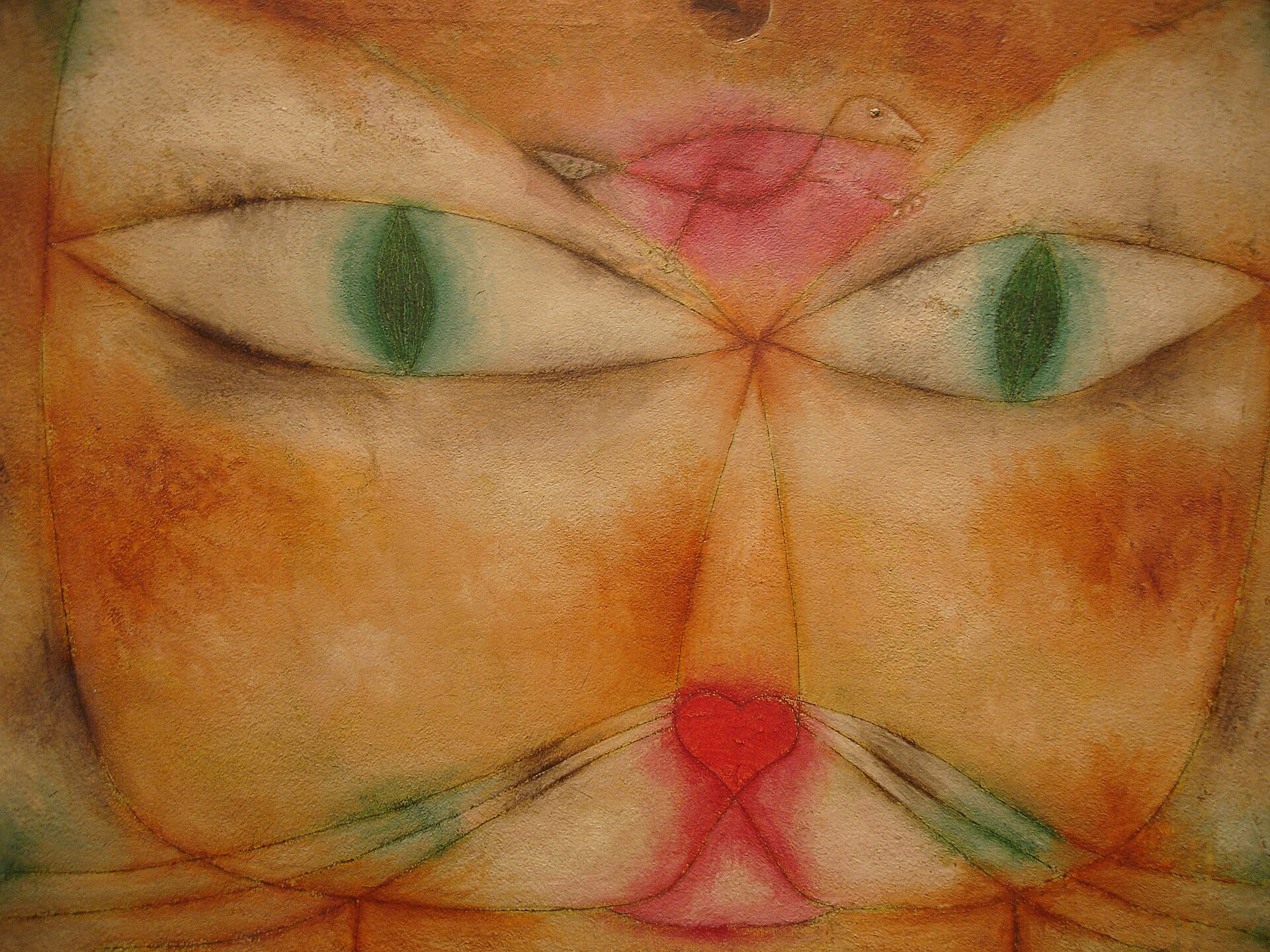 画面いっぱいの猫の顔の額に小さな鳥が描かれ、猫の両目がその鳥へ向く。